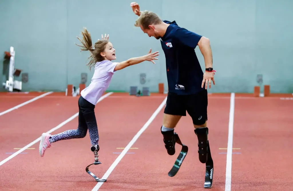 two person with prosthetic leg playing
