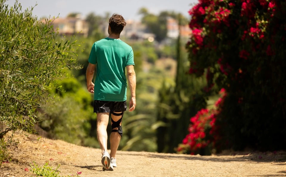 man walking with an oa knee brace