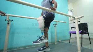 patient practicing gait training exercises with support to improve walking ability after amputation
